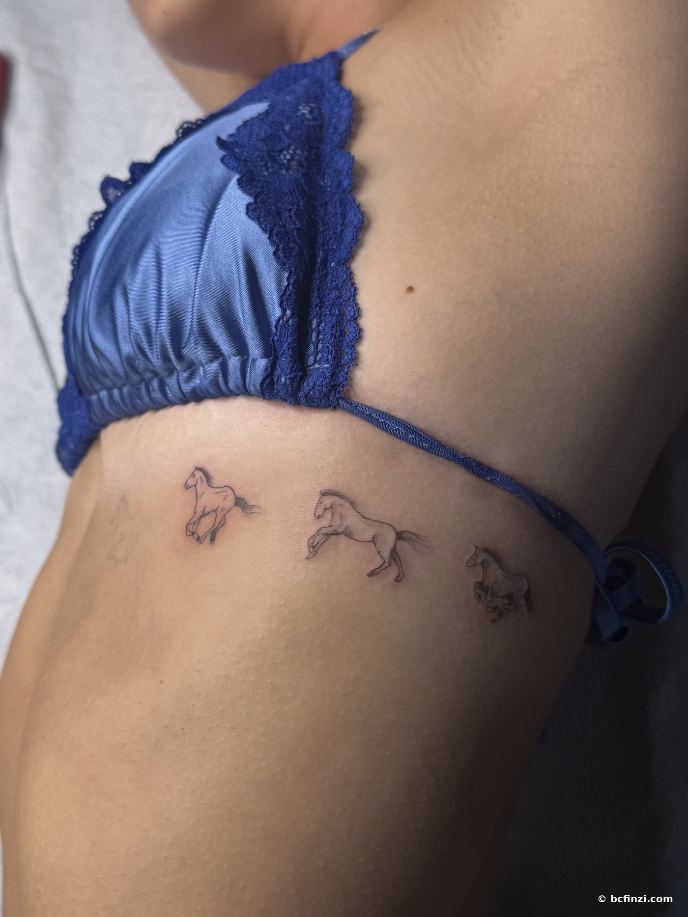 Three horses — fine-line tattoo — on the ribs — by Bianca Finzi, Austin TX